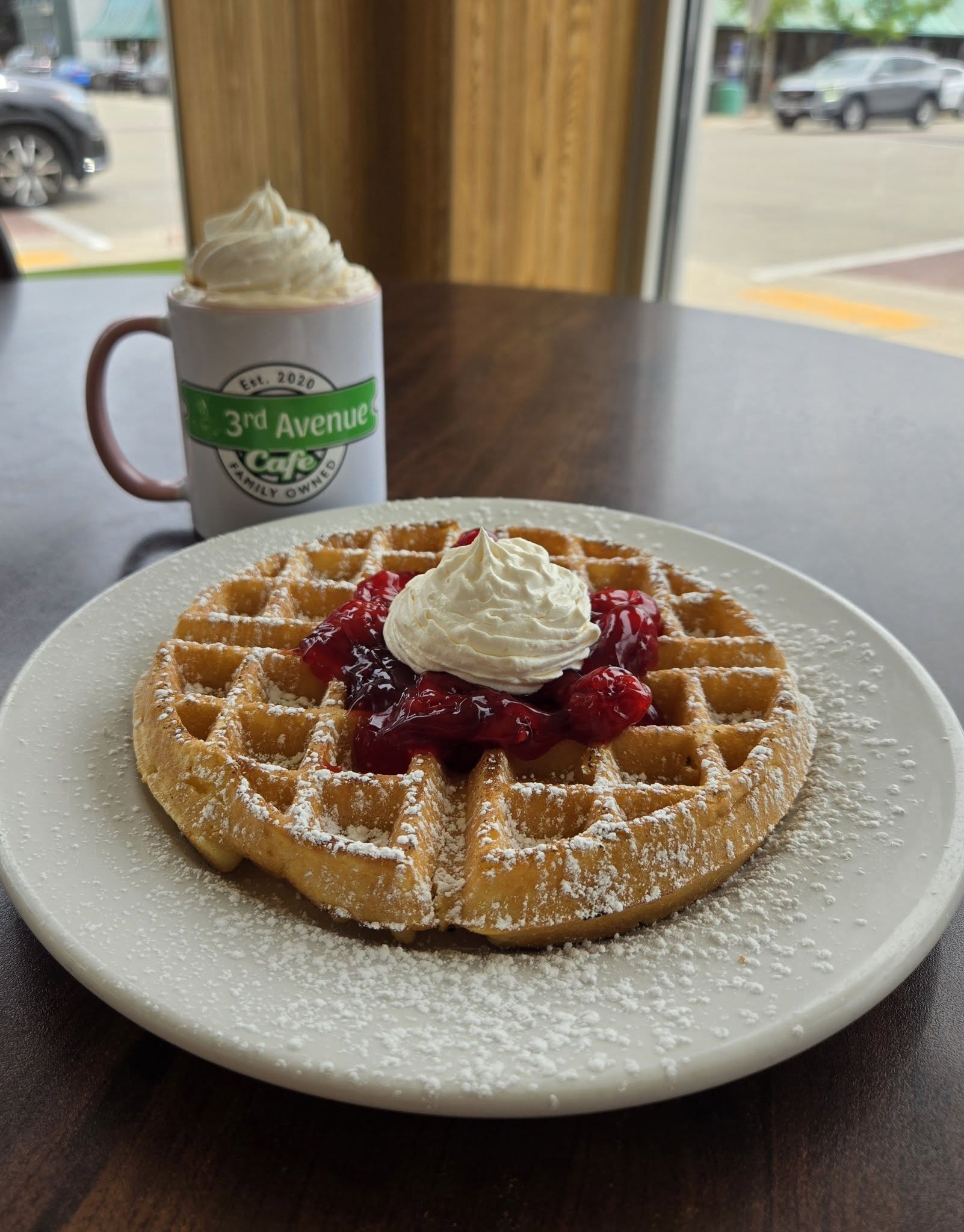Waffle topped with fruit and whipped cream at 3rd Avenue Cafe